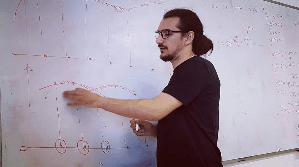 Teaching at whiteboard with mathematical diagrams and student interaction